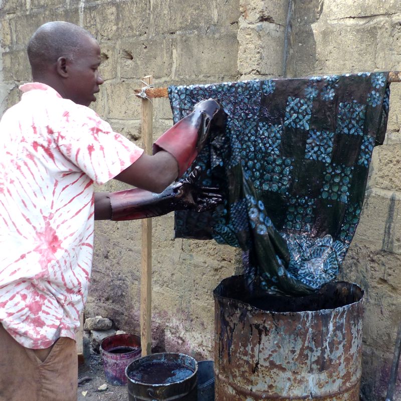 Musa Jaiteh dyeing indigo fabric in The Gambia